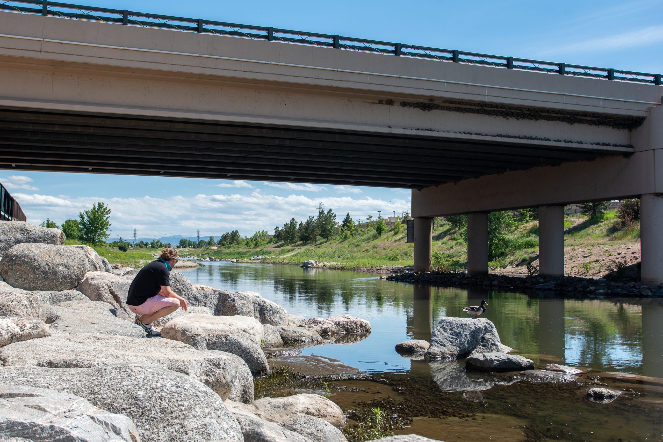 Man Sitting Along River Run